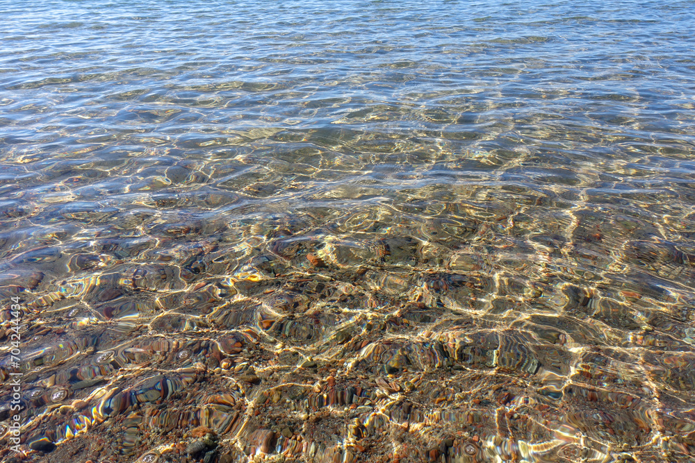 Clean transparent sea water, lake bottom and sand. Beautiful blue, turquoise transparent surface