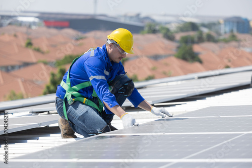 Engineer checking on solar panel on the factory rooftop