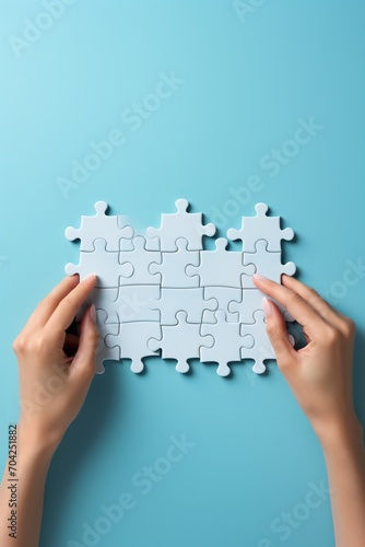 hands holding and fitting puzzle pieces together