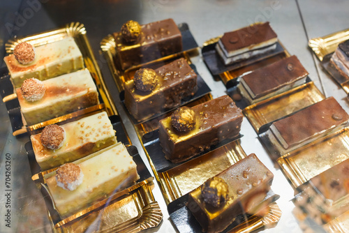Gourmet chocolate and vanilla desserts on golden trays.