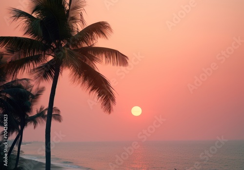  the sun is setting over the ocean with two palm trees in the foreground and a boat in the distance.
