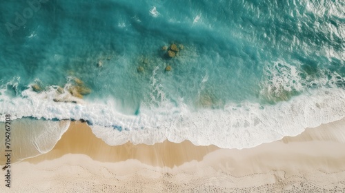  a bird's eye view of a beach with waves crashing on the shore and people swimming in the water.