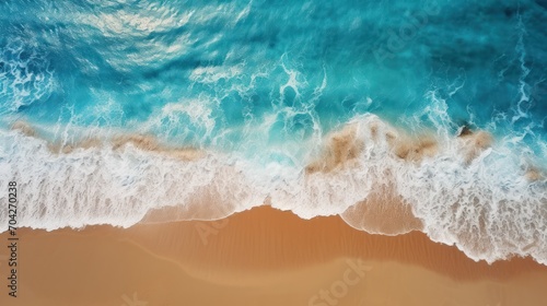  an aerial view of a beach with a wave coming in to the shore and a sandy beach with waves coming in to the shore.