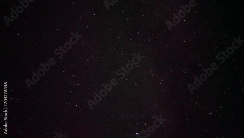 Starry sky. In the center is the constellation Delphinus. At the bottom right you can see one of the brightest stars - Altair. Satellites move across the night sky.
