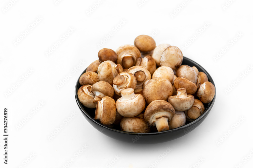 mushrooms champignon in bowl on white background mushrooms champignon in bowl on white background
