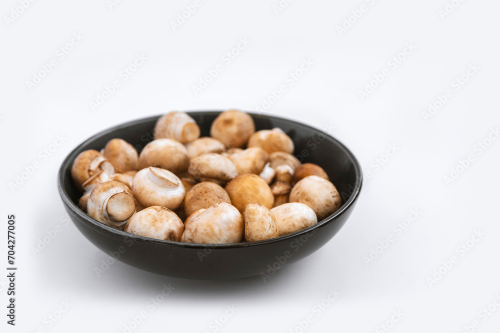 mushrooms champignon in bowl on white background mushrooms champignon in bowl on white background