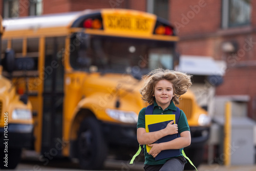 Schoolkid getting on the school bus. American School. Back to school. Kid of primary school. Happy children ready to study. Educational concept.