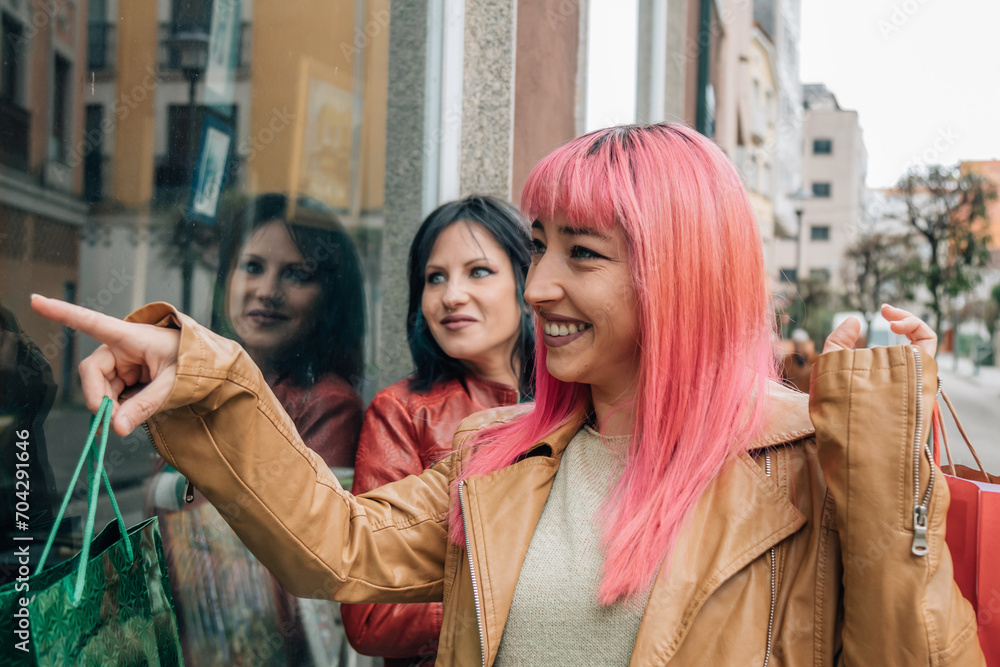 Fototapeta premium female friends shopping with bags on the street