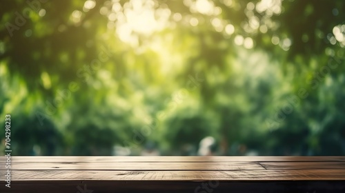 Empty wood table and defocused bokeh and blur background of garden trees with sunlight. product display template. © Inventing Pixel. Inc