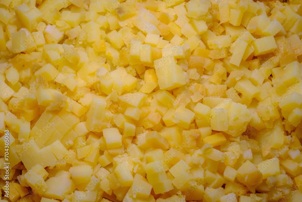 Boiled potatoes cut into small cubes. Making salads in large quantities Boiled potatoes cut into small cubes. Making salads in large quantities