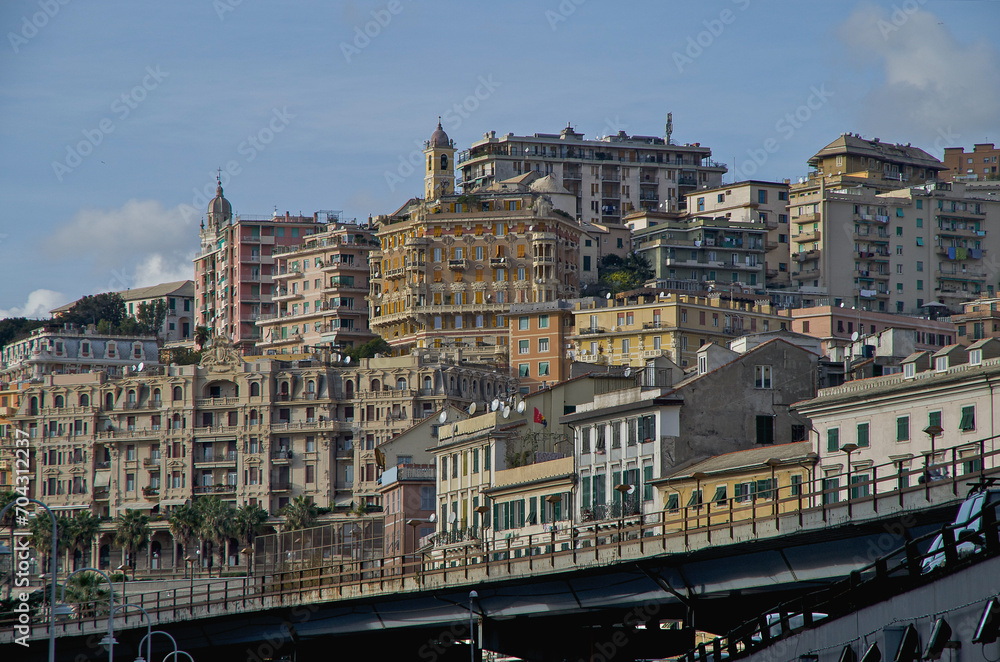 Romantic backstreet, side street or alley in historic old town of Genoa, Italy with historic Mediterranean style architecture facades, a landmark sightseeing tourist spot in downtown