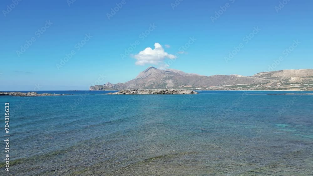 Drone flight over beautiful tiny beach with pink sand in Crete, Greece. Crystal water with small sea waves and natural sea pool. A paradaside with green and blue transparent sea water. Waves movements Drone flight over beautiful tiny beach with pink sand in Crete, Greece. Crystal water with small sea waves and natural sea pool. A paradaside with green and blue transparent sea water. Waves movements