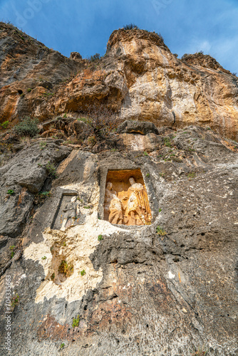 Adamkayalar (literally "man-rocks") is a location in Mersin, Turkey famous for rock-carved figures, facing the gorge, there are carved figures of eleven males, four females and two children one ibex