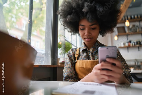 Closeup shot of young black gen z African American girl with afro hair holding cell smart phone scanning qr code to read menu or make payment online in cafe sitting at table, Generative AI 