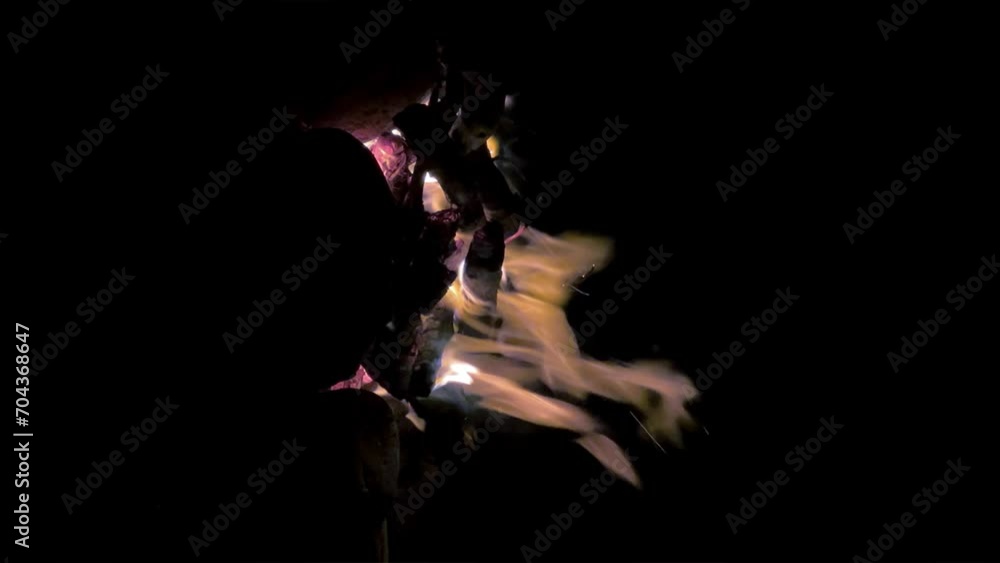 Bonfire on the shore of Lake Issyk-Kul in Kyrgyzstan. Night fire, burning logs, flying sparks. A small torch fire - a small campfire - fire and flames - are highlighted on a black background. 4K Bonfire on the shore of Lake Issyk-Kul in Kyrgyzstan. Night fire, burning logs, flying sparks. A small torch fire - a small campfire - fire and flames - are highlighted on a black background. 4K