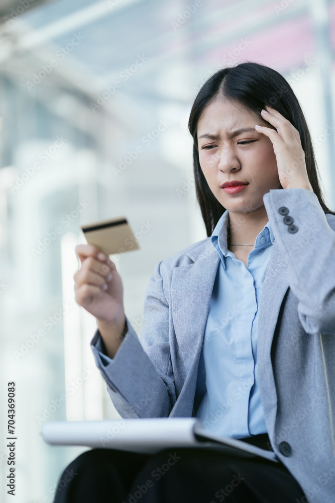Business woman stressed with credit card debt, unemployment stress businessman sitting on stairs. Business woman stressed with credit card debt, unemployment stress businessman sitting on stairs.