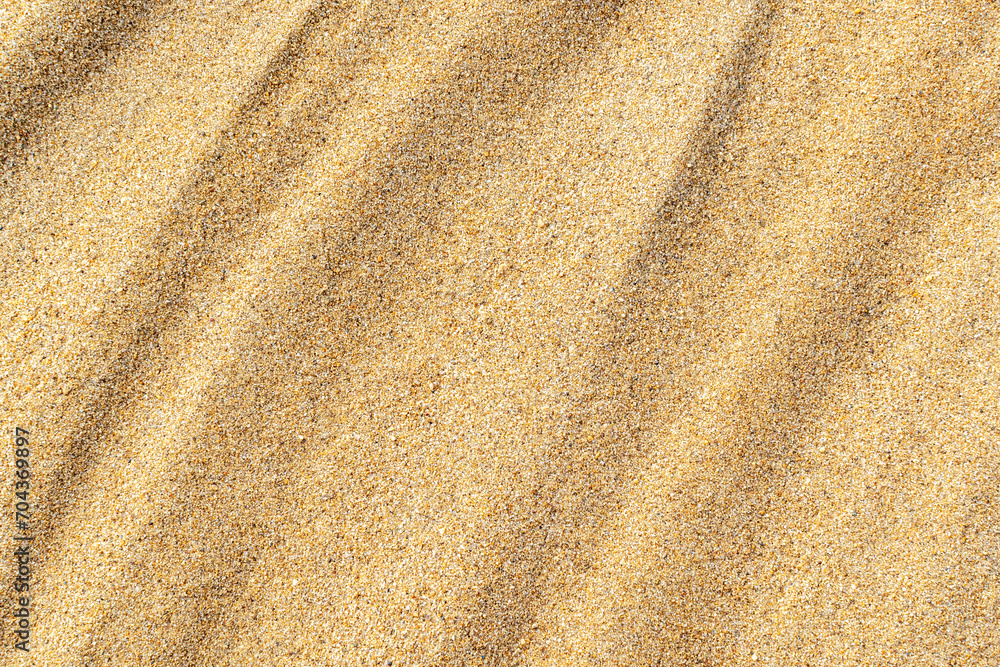 Wavy sand texture close-up. Sandy beach background. Summer, vacation, relax backdrop, top view. Wavy sand texture close-up. Sandy beach background. Summer, vacation, relax backdrop, top view.