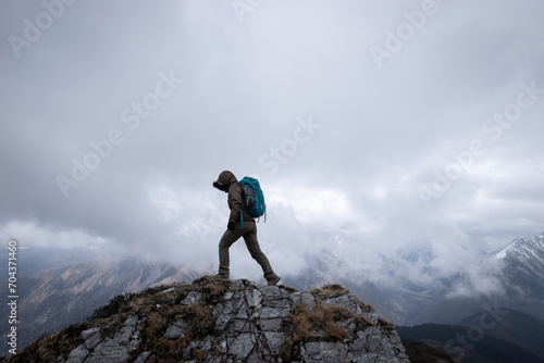 Woman hiker hiking at mountain top in tibet