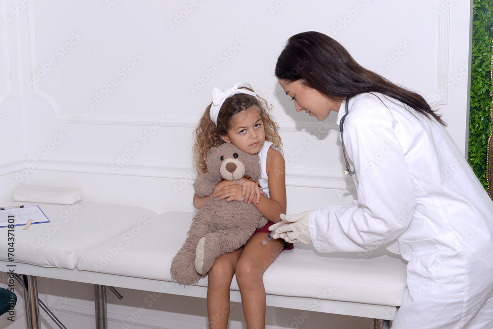 Vaccine fear in children, Little girl in face mask in doctor's office is vaccinated. Crying, scared, afraid of syringe with vaccine coronavirus ,flu, infectious diseases .Clinical trials of injection Vaccine fear in children, Little girl in face mask in doctor's office is vaccinated. Crying, scared, afraid of syringe with vaccine coronavirus ,flu, infectious diseases .Clinical trials of injection