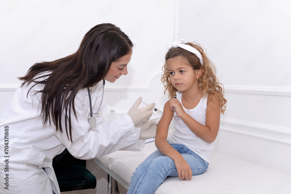 Vaccine fear in children, Little girl in face mask in doctor's office is vaccinated. Crying, scared, afraid of syringe with vaccine coronavirus ,flu, infectious diseases .Clinical trials of injection Vaccine fear in children, Little girl in face mask in doctor's office is vaccinated. Crying, scared, afraid of syringe with vaccine coronavirus ,flu, infectious diseases .Clinical trials of injection