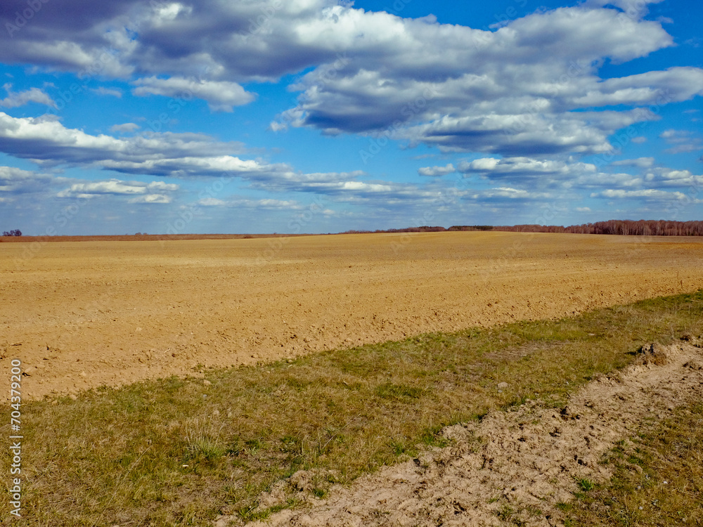 Open landscape, clear skies, and a barren field.