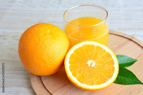 halved orange fruit with glass of orange juice isolated 