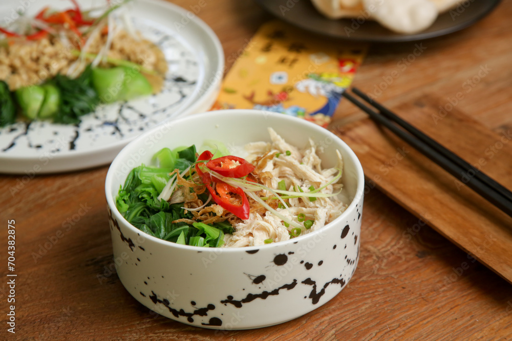 Foods to eat on Lunar New Year’s Eve on the table with golden envelope stuffed with money as a token of good fortune in the New Year. Foods to eat on Lunar New Year’s Eve on the table with golden envelope stuffed with money as a token of good fortune in the New Year.