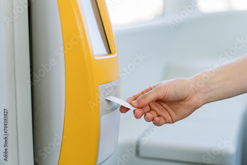 Woman validating mockup paper ticket for public transport. photo