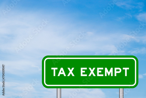 Canvas-taulu Green color transportation sign with word tax exempt on blue sky with white clou