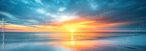 Teal blue with oranges and yellows above the ocean horizon - Fantasy vibrant panoramic sunset sky - Gradient rich colors - ethereal dreamy summer sunset or sunrise sky. Uplifting and peaceful sky.