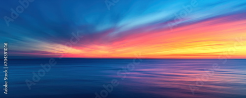 Blue, purple, orange, red, yellow sky - Fantasy vibrant panoramic sunset sky - Gradient rich colors - ethereal dreamy summer sunset or sunrise sky. Uplifting and peaceful sky. #704391046