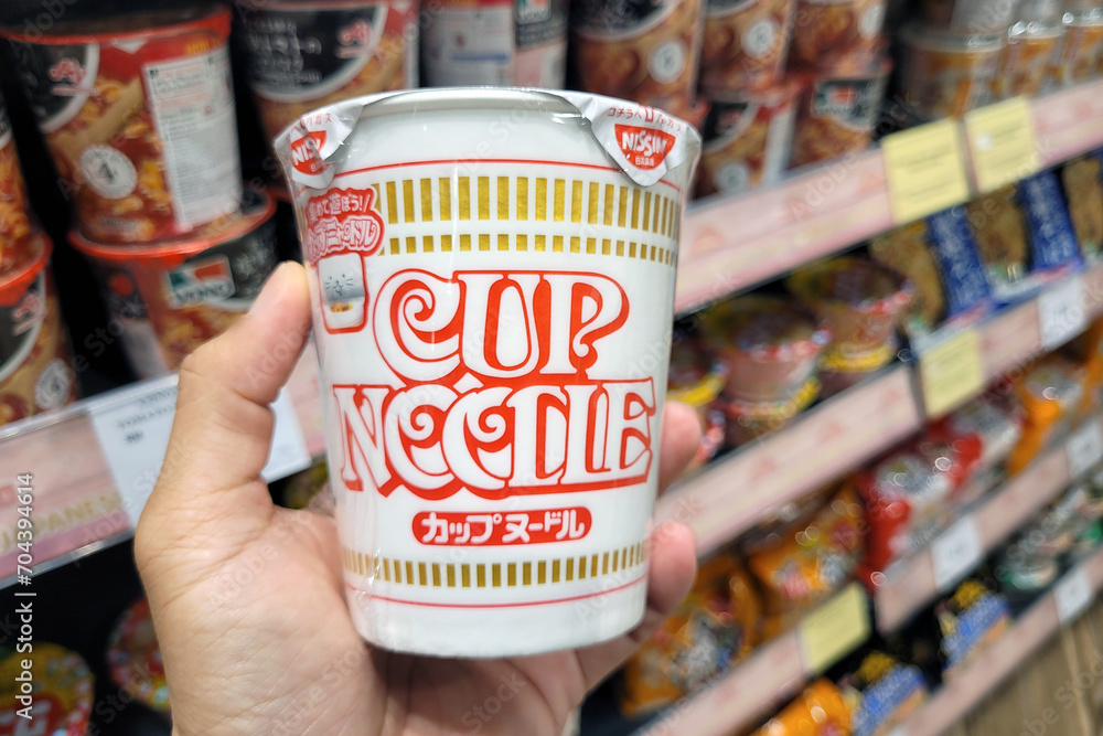 PENANG, MALAYSIA 15 Dec 2023 Adult hand holding a Nissin brand Cup