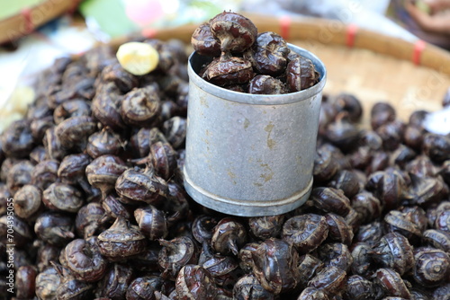 Pile of waternut or Chinese water chestnut in galvanized glass for sale in the market in the north of Thailand photo