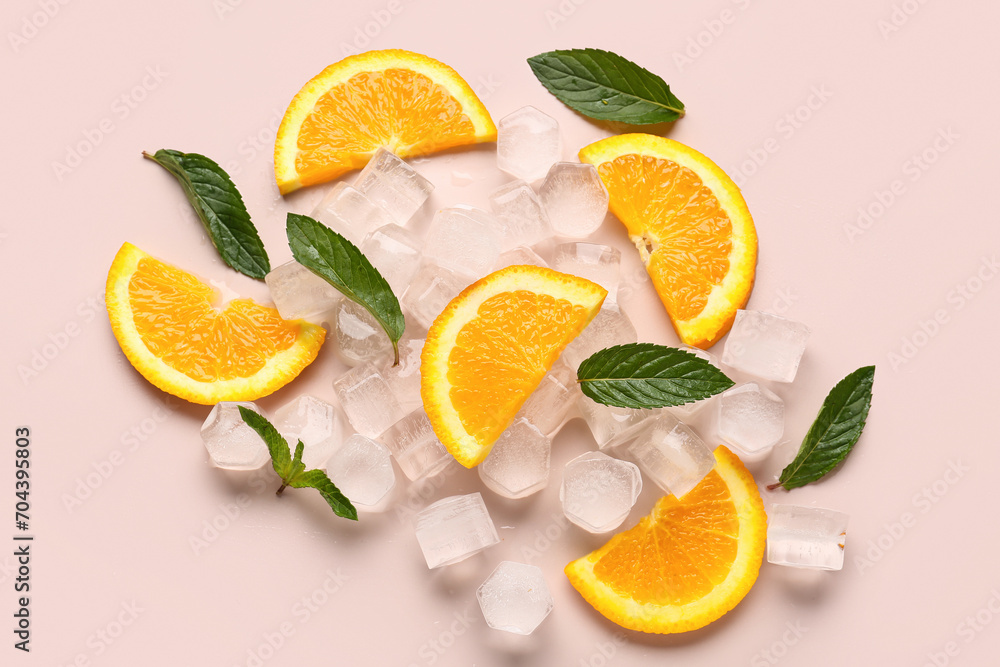 Orange slices with ice cubes and mint on beige background Orange slices with ice cubes and mint on beige background