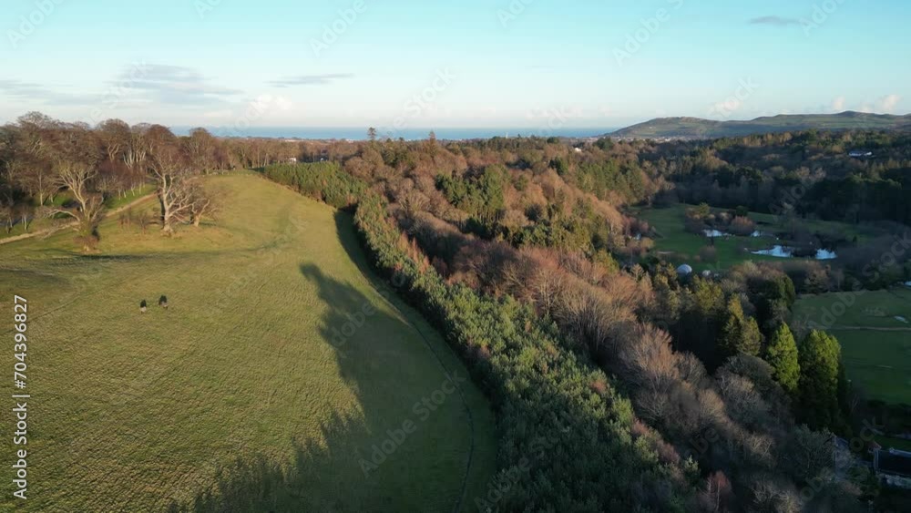 Drone flying over fields and lakes with seaview in Ireland, aerial shot Drone flying over fields and lakes with seaview in Ireland, aerial shot