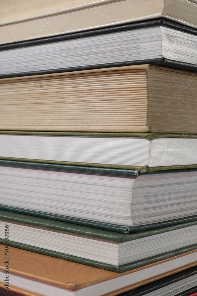 Stack of many different hardcover books as background, closeup Stack of many different hardcover books as background, closeup