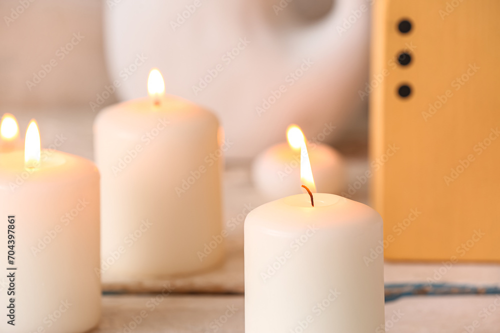 Burning candles on white wooden background Burning candles on white wooden background