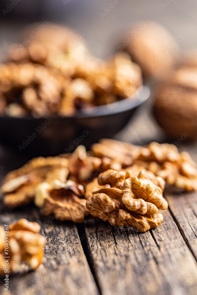 Peeled dried walnut kernels on wooden table. Peeled dried walnut kernels on wooden table.