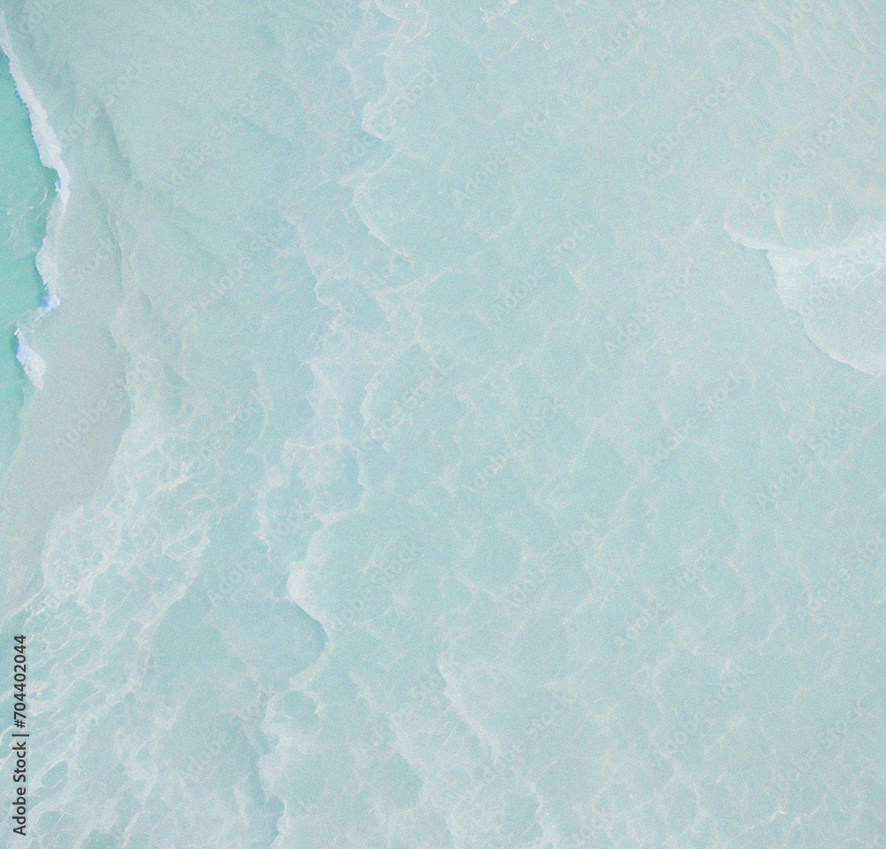 Obraz premium abstract white sand beach with transparent water wave from above, calm rippled water surface background concept with space for text or product presentation