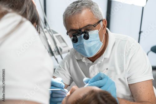 The physician and his assistant work as an outcome-oriented duo aimed at achieving optimal results in the treatment and restoration of oral health. photo