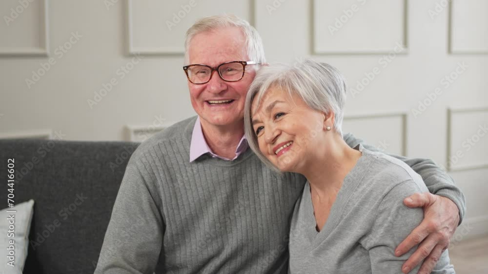 Senior adult mature couple hugging at home. Mid age old husband and wife embracing with tenderness love enjoying sweet bonding wellbeing. Grandmother grandfather together. Family moment love and care Senior adult mature couple hugging at home. Mid age old husband and wife embracing with tenderness love enjoying sweet bonding wellbeing. Grandmother grandfather together. Family moment love and care