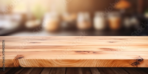 Wood table top on blurred kitchen background - ideal for showcasing or creating product or food montages.