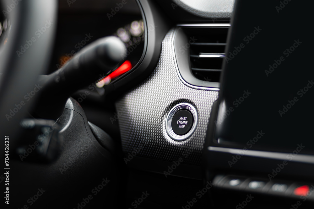 Close up engine start stop button from a modern sport car black luxury interior
