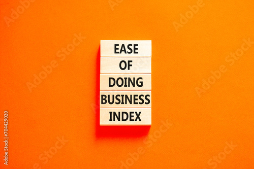 Ease of doing business index symbol. Concept words Ease of doing business index on wooden blocks. Beautiful orange table orange background. Business, ease of doing business index concept. Copy space.