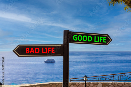Good or bad life symbol. Concept word Good life Bad life on beautiful signpost with two arrows. Beautiful blue sea sky with clouds background. Business and Good or bad life concept. Copy space.