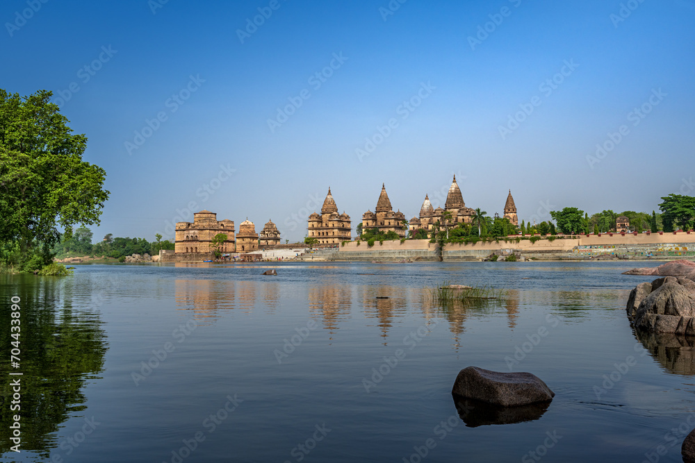 Orchha, India - 02 June 2022 - Royal Chhatris or Cenotaphs are the historical monuments situated on the banks of River Betwa in Orchha, Madhya Pradesh, India. Orchha, India - 02 June 2022 - Royal Chhatris or Cenotaphs are the historical monuments situated on the banks of River Betwa in Orchha, Madhya Pradesh, India.