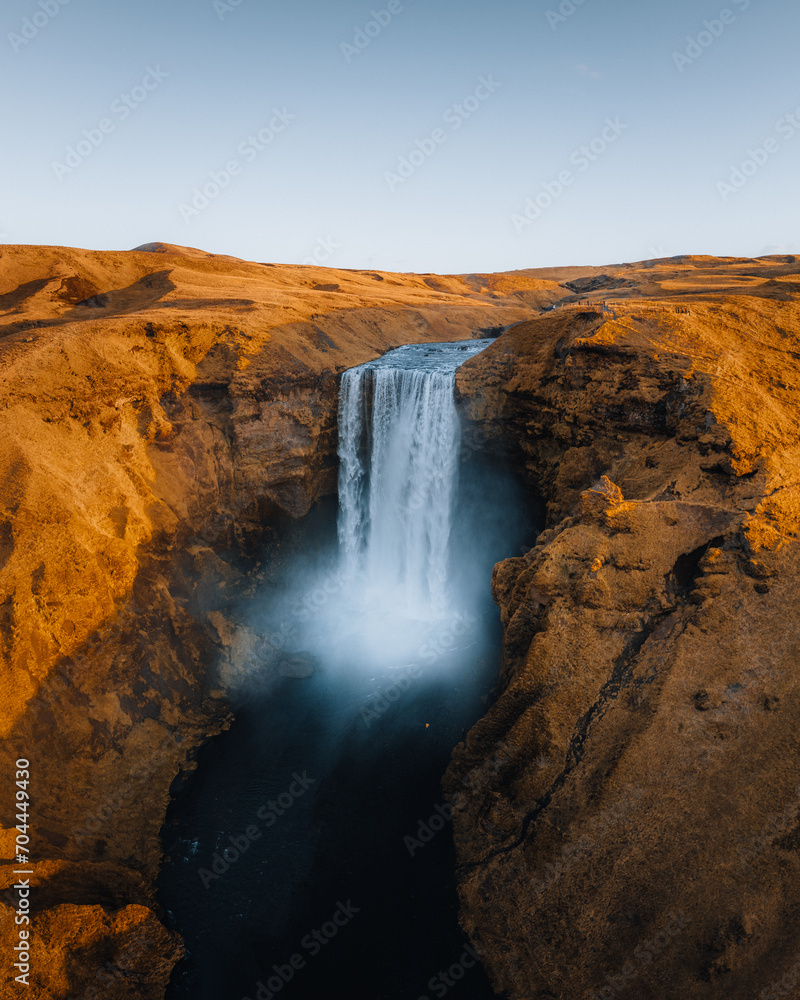 Iceland. Aerial view on the Skogafoss waterfall. Landscape in the Iceland from air. Famous place in Iceland. Landscape from drone. Travel concept. Sunset and sunrise. Soft light.