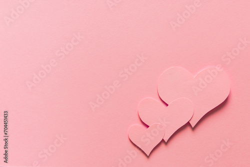 Valentine's day, beautiful three pink hearts on pink background symbol of love with white space for text