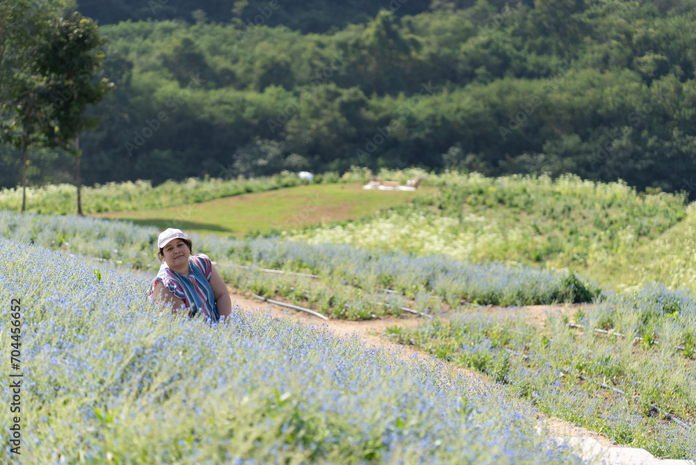 Asian Overweight Woman Travel in Flower Field in Summer Asian Overweight Woman Travel in Flower Field in Summer