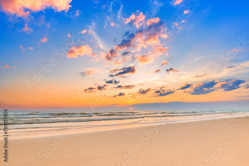 Beautiful calm sunset sky and fluffy clouds over the seascape